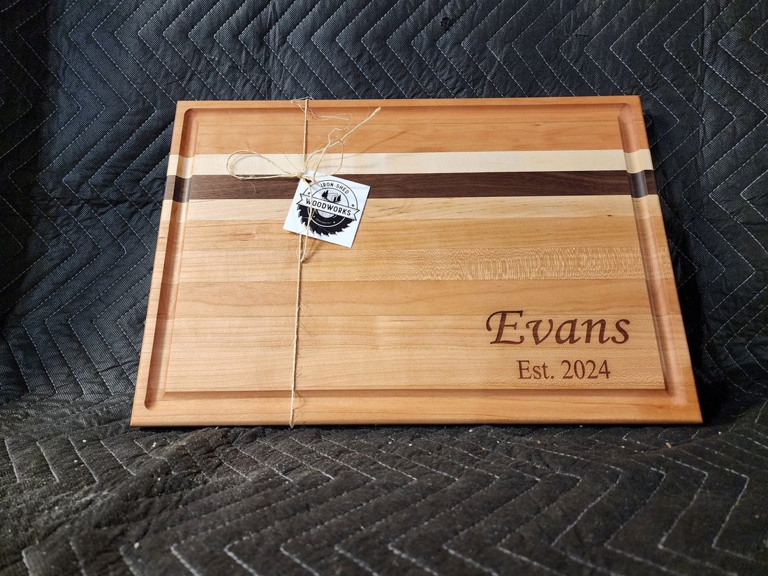 Cherry and maple striped board engraved with a family name and established year